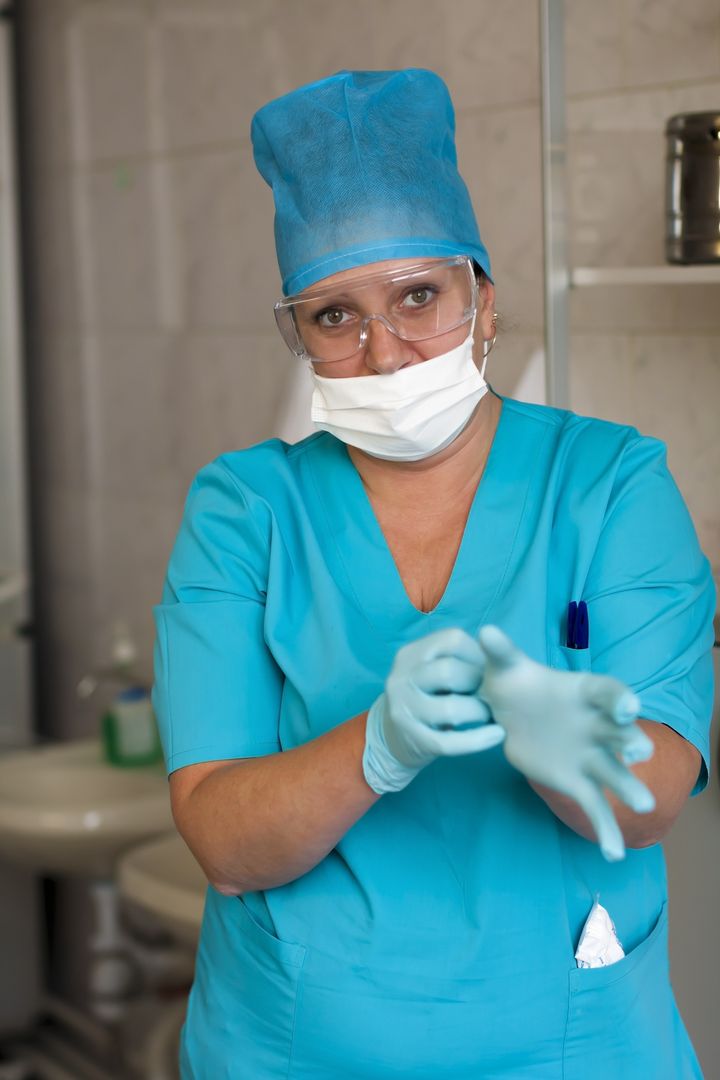 a nurse wears sterile latex...