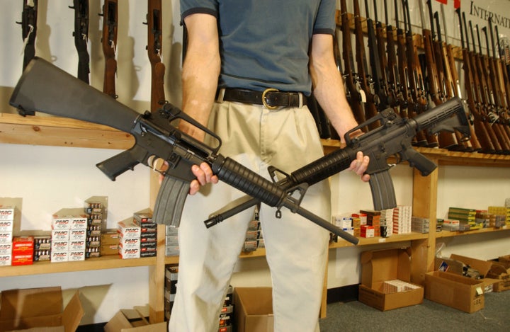 DENVER - SEPTEMBER 13: The Manager of Dave's Guns holds two Colt AR-15's, the gun on the right has a bayonet mount, flash suppressor and a collapsible stock and accepts high capacity magazines that hold over 30 rounds and can be purchased by civilians as of today, the gun on the left was legal to purchase and own with a 10 round magazine September 13, 2004 in Denver, Colorado. Between 1994 and September 13, 2004 the AR-15 with the above items could only be sold to law enforcement and military but is now legal for civilians to purchase due to the expiration of the Brady Bill. (Photo by Thomas Cooper/Getty Images)