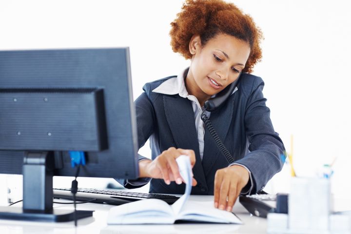 Attractive African American woman busy at workplace