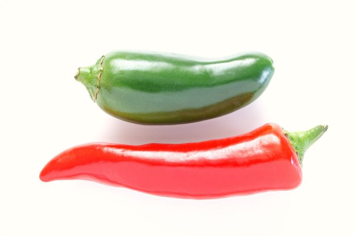 green and red chillies on white ...