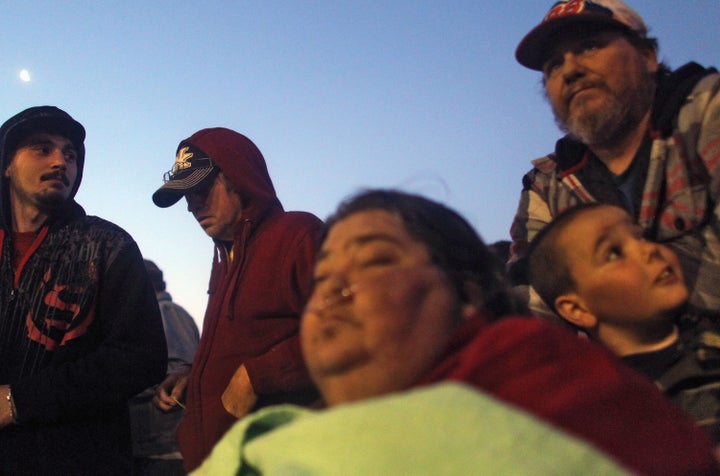 BRISTOL, TN - APRIL 15: Uninsured family Betty (C), James Jr. and James Ramsey (Top R) wait at dawn to attend the Remote Area Medical (RAM) free clinic at the Bristol Motor Speedway, located in the mountains of Appalachia, on April 15, 2012 in Bristol Tennessee. More than one thousand uninsured and underinsured people received free medical, dental, vision and pulmonary treatments provided by volunteer doctors, dentists, optometrists, nurses and support staff during the three day clinic in the foothills of the Appalachian Mountains, one of the poorest regions in the country. The U.S. Supreme Court recently heard arguments over the constitutionality of President Obama's sweeping health care overhaul. (Photo by Mario Tama/Getty Images)