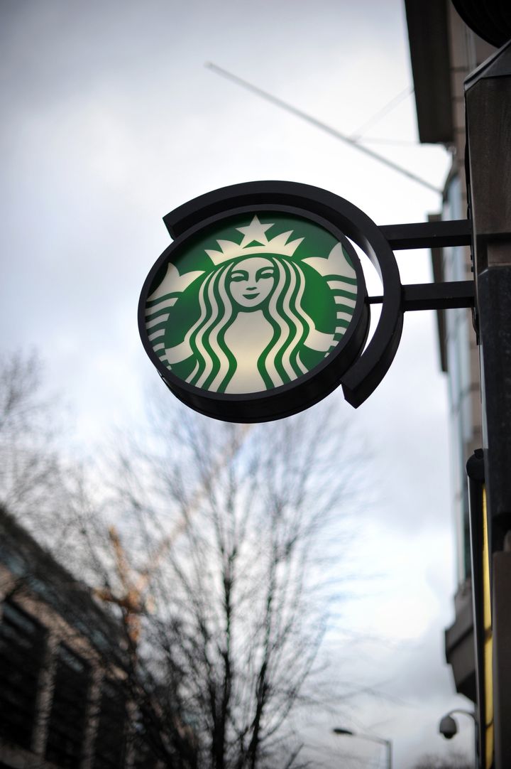 TO GO WITH AFP STORY BY RUTH HOLMES A Starbucks sign is pictured outside a branch of the coffee shop in central London on February 1, 2013. Despite pledging to pay millions of pounds in extra tax in Britain, Starbucks faces a battle to restore its reputation over its fiscal stance, with analysts saying the offer is 'too little too late'. AFP PHOTO / CARL COURT (Photo credit should read CARL COURT/AFP/Getty Images)