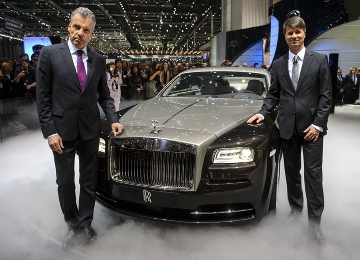 Rolls Royce CEO Torsten Mueller-Oetvoes (L) and Chaiman Harald Krueger pose with the new Rolls Royce the Wraith model car presented in world premiere at the British car maker's booth at the Geneva International Motor Show on March 5, 2013. The Geneva International Motor Show opened its doors to the press under a dark cloud, with no sign of a speedy rebound in sight for the troubled European market. The event, which is considered one of the most important car shows of the year, will again be heavily marked by the crisis in Europe after an already catastrophic year in 2012. AFP PHOTO / FABRICE COFFRINI (Photo credit should read FABRICE COFFRINI/AFP/Getty Images)