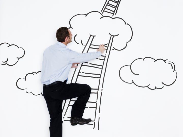 Businessman climbing ladder