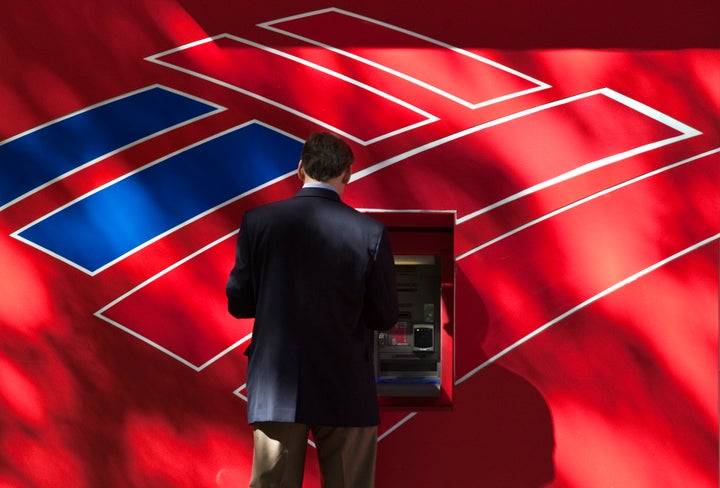 CHARLOTTE, NC - OCTOBER 24: A man uses a Bank of America ATM on Tryon Street on October 24, 2012 in Charlotte, North Carolina. The federal government is suing Bank of America Corp. for $1 billion over mortgages sold to Fannie Mae and Freddie Mac. (Photo by John Adkisson/Getty Images)