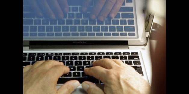 This photo illustration shows hands typing on a computer keyboard on Wednesday Feb. 27,2013. Security threats aren't new and have long been part of online life. But the increased attention on them offers a good time to review ways you can protect yourself. (AP Photo/Damian Dovarganes)