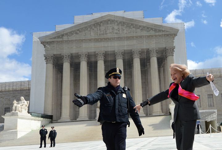Plaintiff of the US v. Windsor case challenging the constitutionality of Section 3 of the Defense of Marriage Act (DOMA), 83-year-old lesbian widow Edie Windsor (C), greets same-sex marriage supporters as she leaves the Supreme Court on March 27, 2013 in Washington, DC. The US Supreme Court tackled same-sex unions for a second day Wednesday, hearing arguments for and against the 1996 US law defining marriage as between one man and one woman. After the nine justices mulled arguments on a California law outlawing gay marriage on Tuesday, they took up a challenge to the constitutionality of the federal Defense of Marriage Act (DOMA). The 1996 law prevents couples who have tied the knot in nine states -- where same-sex marriage is legal -- from enjoying the same federal rights as heterosexual couples. AFP PHOTO/Jewel Samad (Photo credit should read JEWEL SAMAD/AFP/Getty Images)