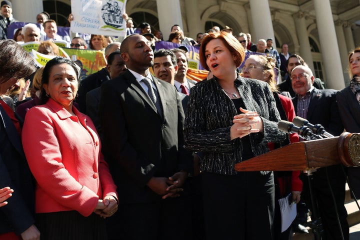 NEW YORK, NY - MARCH 29: New York City Council Speaker Christine Quinn (4th R) speaks at a rally in front of City Hall to show support for a paid sick leave bill, a day after she announced that lawmakers and advocates reached a deal on the legislation March 29, 2013 in New York City. The bill would force businesses with 20 or more employees to provide five paid sick days a year beginning in April 2014. New York Mayor Michael Bloomberg, who opposes the bill, said he would veto it if it comes to his desk. (Photo by Spencer Platt/Getty Images)