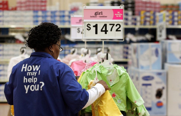 EVERGREEN PARK, IL - JANUARY 26: Wal-Mart sales associate Cherry Williams from Chicago arranges girl infant/toddler clothing at the new Wal-Mart store January 26, 2006 in Evergreen Park, Illinois. Wal-Mart reportedly had at this store, located just outside the city limits of Chicago, over 25,000 applicants for 325 jobs, with 90 percent of the applications coming from Chicago. This new store is set to open tomorrow morning. (Photo by Tim Boyle/Getty Images)