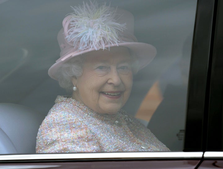 Britain's Queen Elizabeth II smiles from inside her car as she leaves The Deanery at St Georges Chapel in Windsor Castle afte