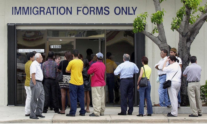 MIAMI, : A line forms near the entrance of the Immigration and Naturalization Service office in Miami, 30 April 2001, as the