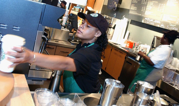 NEW YORK - AUGUST 5: A Starbucks Coffee barrista readies a beverage for a customer in the new 42nd Street store August 5, 2003 in New York City. The Seattle-based coffee company has emerged as the largest food chain in the Manhattan borough of New York with 150 outlets. (Photo by Stephen Chernin/Getty Images)