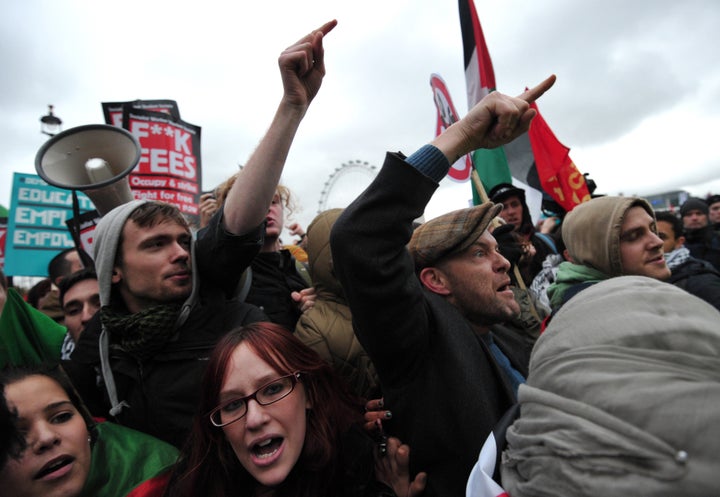 Protestors shout at police during a student rally in central London on November 21, 2012 against sharp rises in university tuition fees, funding cuts and high youth unemployment. AFP PHOTO/CARL COURT (Photo credit should read CARL COURT/AFP/Getty Images)