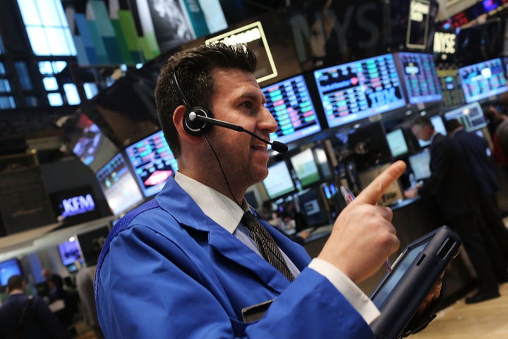 NEW YORK, NY - APRIL 09: Traders work on the floor of the New York Stock Exchange on April 9, 2013 in New York City. The Dow Jones Industrial Average hit a new record trading high of 14,706 today, while closing slightly lower at 14,673.46. (Photo by Spencer Platt/Getty Images)