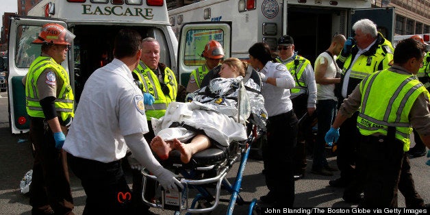 BOSTON - APRIL 15: A patient is transported to an ambulance from a medical tent at Copley Square in Boston after two explosions went off during the Boston Marathon on April 15, 2013. (Photo by John Blanding/The Boston Globe via Getty Images)