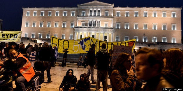 Protesters demonstrate outside the parliament against the austerity measures of Greek and Cypriot governments on March 31, 2013. AFP PHOTO / ARIS MESSINIS (Photo credit should read ARIS MESSINIS/AFP/Getty Images)