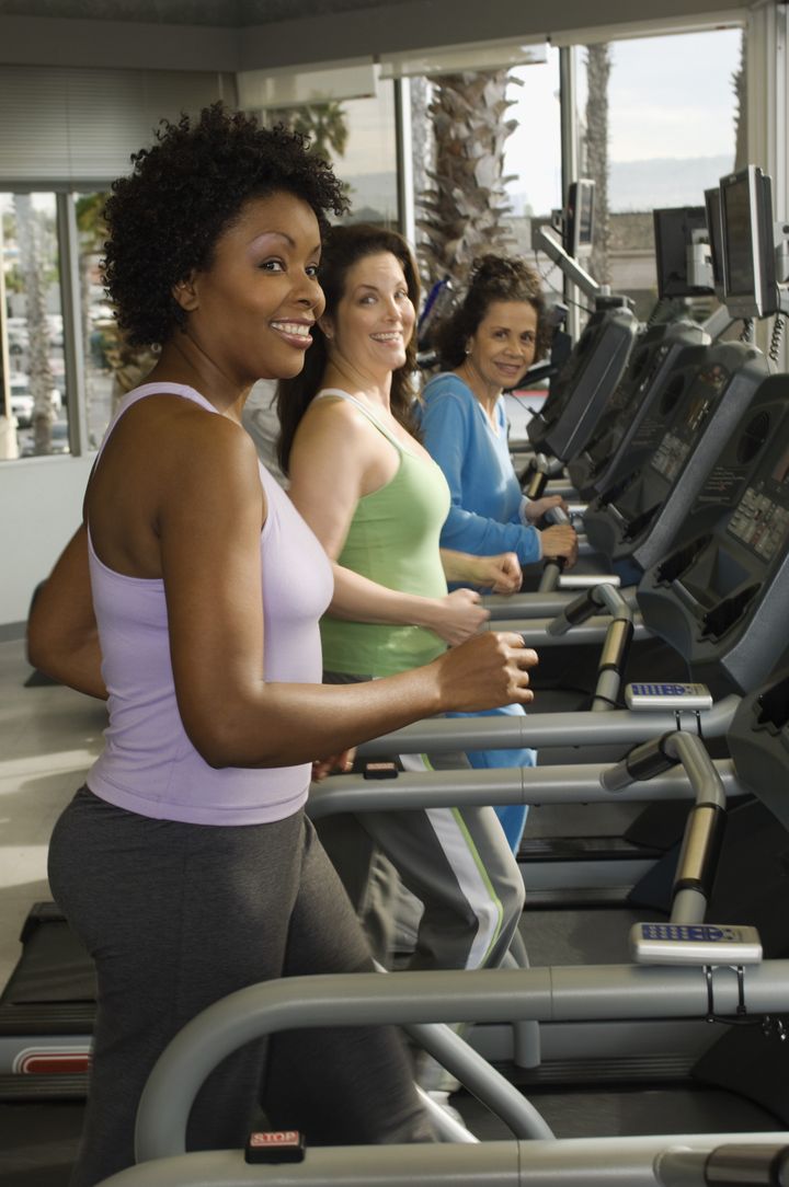 Multi ethnic women exercising on treadmill