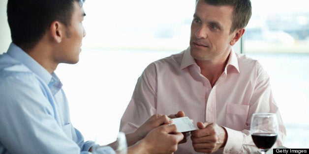 Businessmen exchanging business cards