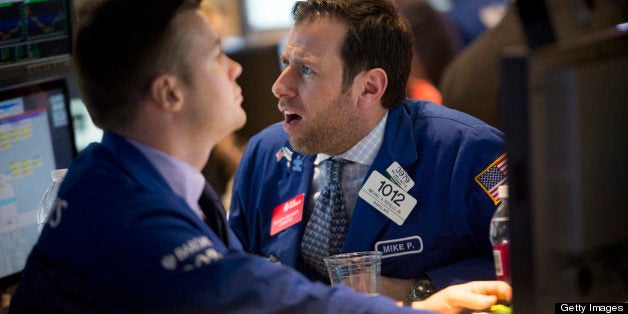 Traders work on the floor of the New York Stock Exchange (NYSE) in New York, U.S., on Wednesday, April 17, 2013. U.S. stocks sank, erasing yesterday's rally, amid losses in industrial metals and disappointing results from Bank of America Corp. The euro slid as German central bank chief Jens Weidmann reportedly said European policy makers may cut rates if needed. Photographer: Scott Eells/Bloomberg via Getty Images