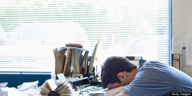 Mixed race man laying on desk