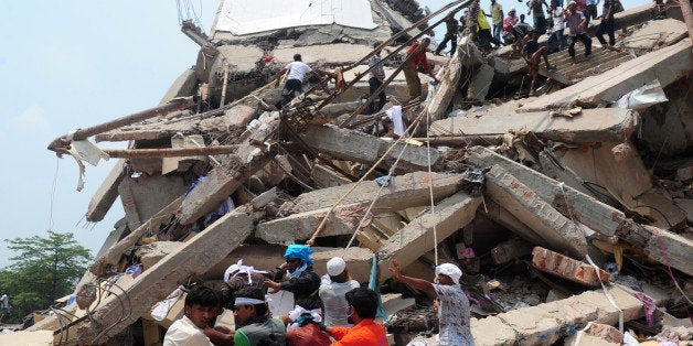 Bangladeshi volunteers and rescue workers are pictured at the scene after an eight-storey building collapsed in Savar, on the outskirts of Dhaka, on April 25, 2013. Survivors cried out to rescuers April 25 from the rubble of a block of garment factories in Bangladesh that collapsed killing 175 people, sparking criticism of their Western clients. AFP PHOTO/Munir uz ZAMAN (Photo credit should read MUNIR UZ ZAMAN/AFP/Getty Images)