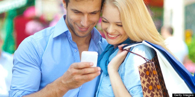 close up of a young couple looking at mobile phone