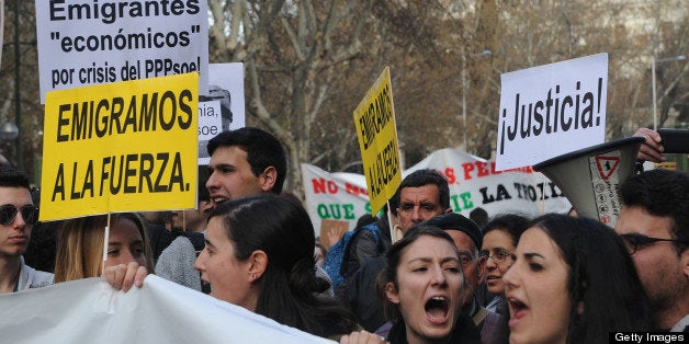 Spanish youth hold placards reading 'We are forced to emigrate' or 'Justice!' as they take part in protest against government's austerity measures forcing them to emigrate, in Madrid on April 7, 2013. AFP PHOTO/ DOMINIQUE FAGET (Photo credit should read DOMINIQUE FAGET/AFP/Getty Images)