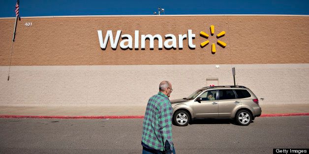 A customer walks outside a Wal-Mart store in East Peoria, Illinois, U.S., on Wednesday, Feb. 20, 2013. Wal-Mart Stores Inc., the world?s largest retailer, projected first-quarter profit that trailed analysts? estimates as an increase in the payroll tax and delayed refunds curtail spending by its lower-income shoppers. Photographer: Daniel Acker/Bloomberg via Getty Images