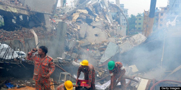 Bangladeshi fire-fighters try to control a blaze after a fire broke out during a rescue attempt of a woman as Bangladeshi Army personel begin the second phase of the rescue operation using heavy equipment after an eight-storey building collapsed in Savar, on the outskirts of Dhaka, on April 29, 2013. Thousands of Bangladeshi garment workers walked out of their factories Monday, demanding the death penalty for the owner of a tower block that collapsed and killed at least 381 of their colleagues. AFP PHOTO/MUNIR UZ ZAMAN (Photo credit should read MUNIR UZ ZAMAN/AFP/Getty Images)