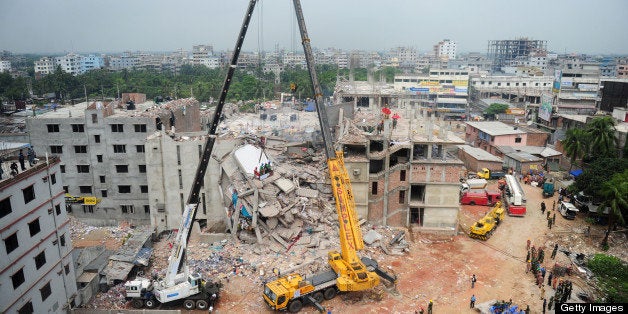 Bangladeshi rescuers work as Bangladeshi Army personel begin the second phase of the rescue operation using heavy equipment after an eight-storey building collapsed in Savar, on the outskirts of Dhaka, on April 29, 2013. Thousands of Bangladeshi garment workers walked out of their factories Monday, demanding the death penalty for the owner of a tower block that collapsed and killed at least 381 of their colleagues. AFP PHOTO/MUNIR UZ ZAMAN (Photo credit should read MUNIR UZ ZAMAN/AFP/Getty Images)