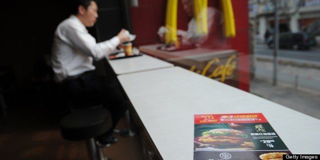 A leaflet on a table in McDonald's advertises discount on chicken McNuggets at a branch in Shanghai on April 9, 2013. The Fast food giant slashed prices by more than 40 percent on a chicken item, offering 20 McNuggets for 20 yuan ($3.17) while emphasising its food was safe in a publicity campaign. AFP PHOTO/Peter PARKS (Photo credit should read PETER PARKS/AFP/Getty Images)