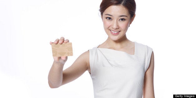 Young business lady holding credit card