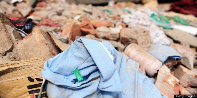 A shirt with a Benetton label lies in the rubble three days after a Bangladeshi garment eight-storey building collapsed in Savar, on the outskirts of Dhaka, on April 27, 2013. Police arrested two textile bosses over a Bangladeshi factory disaster as the death toll climbed to 332 and distraught relatives lashed out at rescuers trying to detect signs of life. AFP PHOTO/ Munir uz ZAMAN (Photo credit should read MUNIR UZ ZAMAN/AFP/Getty Images)