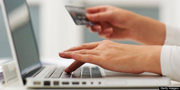 Woman using laptop computer and credit card to do shopping.
