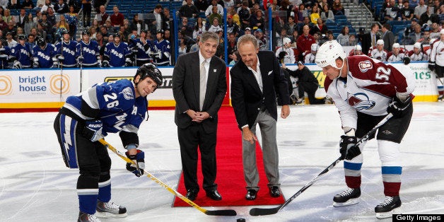 TAMPA, FL -DECEMBER 4: Steve Yerrid drops the ceremonial puck with Jeffery Vinik, owner of the Tampa Bay Lightning along with players Martin St. Louis #26 of the Tampa Bay Lightning and Adam Foote #52 of the Colorado Avalanche at the St. Pete Times Forum on December 4, 2010 in Tampa, Florida. (Photo by Scott Audette/NHLI via Getty Images)