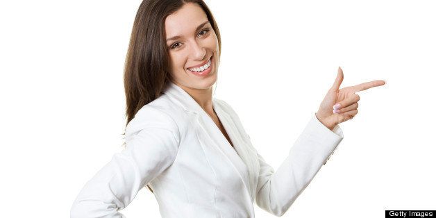 Confident young businesswoman gesturing on white.