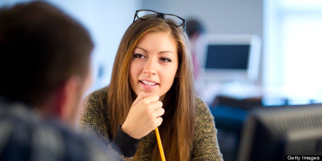 young woman working in an office with her colleague.http://www.stuartrayner.com/teenjob.jpg