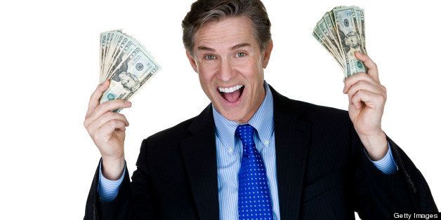 Horizontal composition of a mature man wearing a suit and holding money 