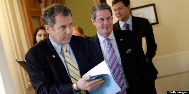 WASHINGTON, DC - APRIL 24: Sen. Sherrod Brown (D-OH) (L) and Sen. David Vitter (R-LA) (R) arrive for a press conference announcing the details of 'Too Big to Fail' legislation at the U.S. Capitol April 24, 2013 in Washington, DC. The legislation would include capital requirements for financial institutions to protect against losses and prevent the use of federal funds to bail them out should they fail. (Photo by Win McNamee/Getty Images)