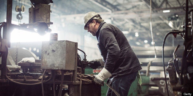 Man Working At Steel Cutting Machine