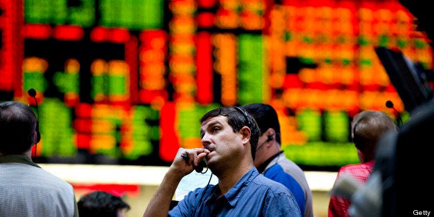 Traders work in the ten-year U.S. Treasury Note options pit at the Chicago Board of Trade in Chicago, Illinois, U.S., on Wednesday, Oct. 24, 2012. The Federal Reserve said the economy is still growing modestly and unemployment remains elevated as it maintains $40 billion in monthly purchases of mortgage-backed securities aimed at spurring the three-year expansion. Photographer: Daniel Acker/Bloomberg via Getty Images