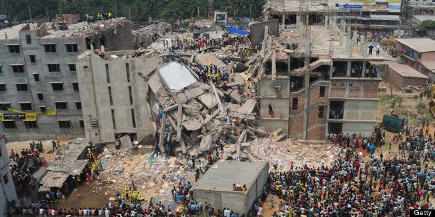 Bangladeshi volunteers and rescue workers are pictured at the scene after an eight-storey building collapsed in Savar, on the outskirts of Dhaka, on April 25, 2013. Survivors cried out to rescuers April 25 from the rubble of a block of garment factories in Bangladesh that collapsed killing 175 people, sparking criticism of their Western clients. AFP PHOTO/Munir uz ZAMAN (Photo credit should read MUNIR UZ ZAMAN/AFP/Getty Images)