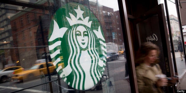 A customer exits a Starbucks Corp. location in New York, U.S., on Tuesday, April 23, 2013. Arabica-coffee futures fell the most in seven weeks on speculation that ample supply in Brazil, the world's leading producer and exporter, will compensate for production losses from a fungal disease in Central America. Photographer: Scott Eells/Bloomberg via Getty Images