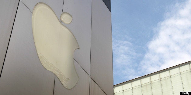 The Apple Inc. logo is displayed outside the company's store in Tokyo, Japan, on Sunday, June 23, 2013. Samsung and Apple, the worlds two biggest smartphone makers, have each scored victories in patent disputes fought over four continents since the maker of the iPhone accused Asias biggest electronics maker of slavishly copying its devices. Photographer: Koichi Kamoshida/Bloomberg via Getty Images