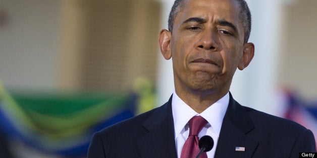US President Barack Obama reacts during a joint press conference following meetings with Tanzanian President at the State Hou