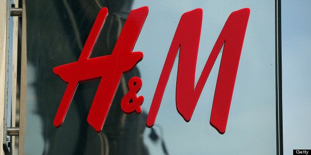 The Hennes & Mauritz AB (H&M) company logo hangs at a store in London, U.K., on Wednesday, June 23, 2010. Hennes & Mauritz AB, Europe's second-largest clothing retailer, is looking at opening its first store in the southern hemisphere to tap emerging-market growth and catch up with larger rival Inditex SA. Photographer: Simon Dawson/Bloomberg via Getty Images