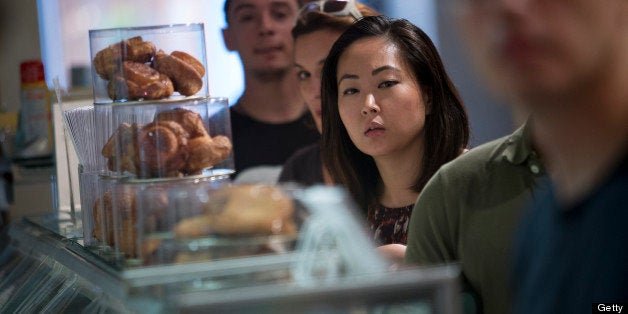 Customers wait in line to make purchases at the Dominique Ansel Bakery in New York, U.S., on Thursday, June 27, 2013. Customers begin lining up early in the morning for the latest food craze, Cronuts, a croissant and doughnut hybrid, created by chef Dominique Ansel. Photographer: Scott Eells/Bloomberg via Getty Images