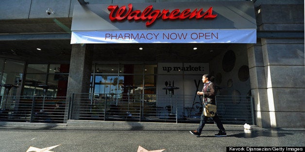 HOLLYWOOD, CA - JANUARY 15: A woman walk past a new Walgreens at the corner of Sunset and Vine on January 15, 2013 in Hollywood, California. The new 23,500-square-foot, drugstore, the company's 8,000th store and first West Coast flagship, includes high-end cosmetic, skinand hair care brands, a frozen yogurt station, a fresh sushi bar, a coffee and espresso bar, a juice and smoothie bar, a wine and spirits shop with a and a virtual bartender kiosk and a cigar humidor. (Photo by Kevork Djansezian/Getty Images)