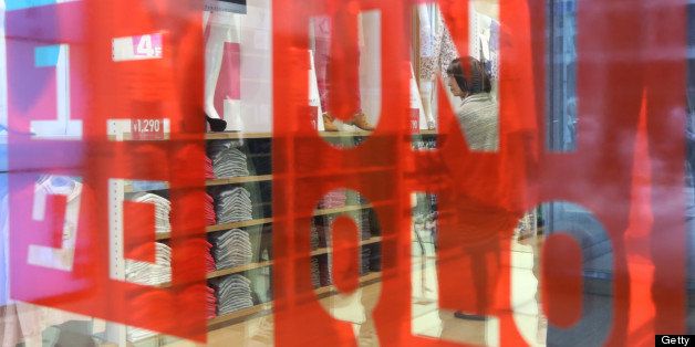 Fast Retailing Co.'s Uniqlo logo is displayed at the front of the store in the Ginza district of Tokyo, Japan, on Wednesday, April 10, 2013. Fast Retailing, Asia?s largest apparel retailer, is scheduled to announce earnings tomorrow. Photographer: Yuriko Nakao/Bloomberg via Getty Images 