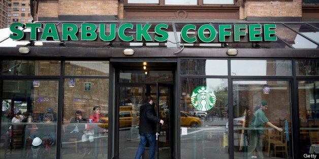 A customer enters a Starbucks Corp. location in New York, U.S., on Tuesday, April 23, 2013. Arabica-coffee futures fell the most in seven weeks on speculation that ample supply in Brazil, the world's leading producer and exporter, will compensate for production losses from a fungal disease in Central America. Photographer: Scott Eells/Bloomberg via Getty Images